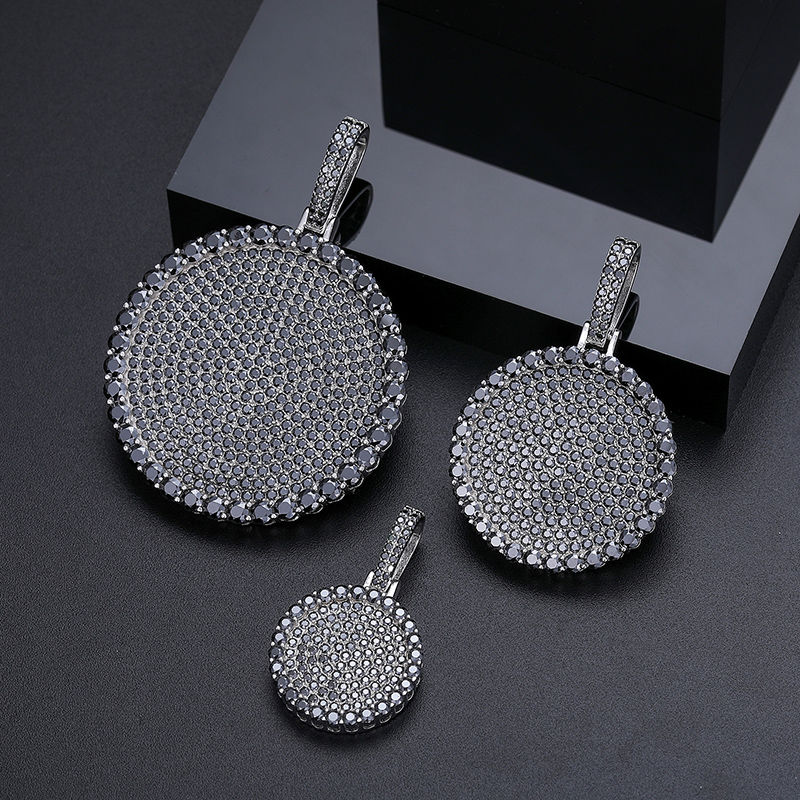 Thumbnail: Three round rhinestone pendants isolated on a dark surface jewelry accessories
