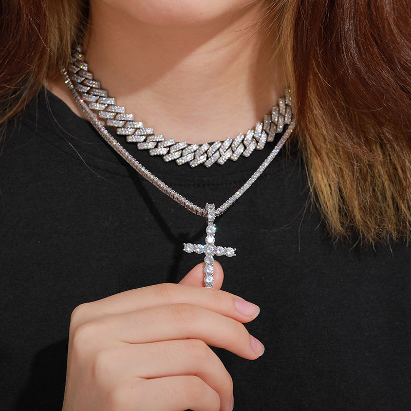 Thumbnail: Woman wearing diamond cross pendant and cuban chain necklaces. jewlery