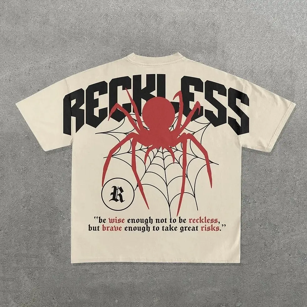 Thumbnail: Cream oversized t-shirt with RECKLESS spider graphic and quote about risks.
