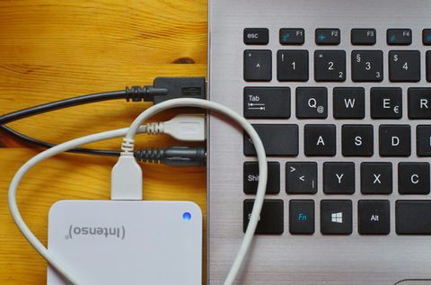laptop computer with usb cables and external hard drive plugged in