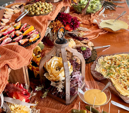 Beautifully arranged catering buffet with artisan cheeses, charcuterie, fresh fruit, appetizers, and gourmet spreads for special occasions.