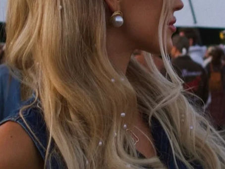 blonde girl with gems in her hair at a music festival