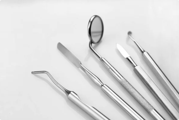 Silver dentist tools on white background