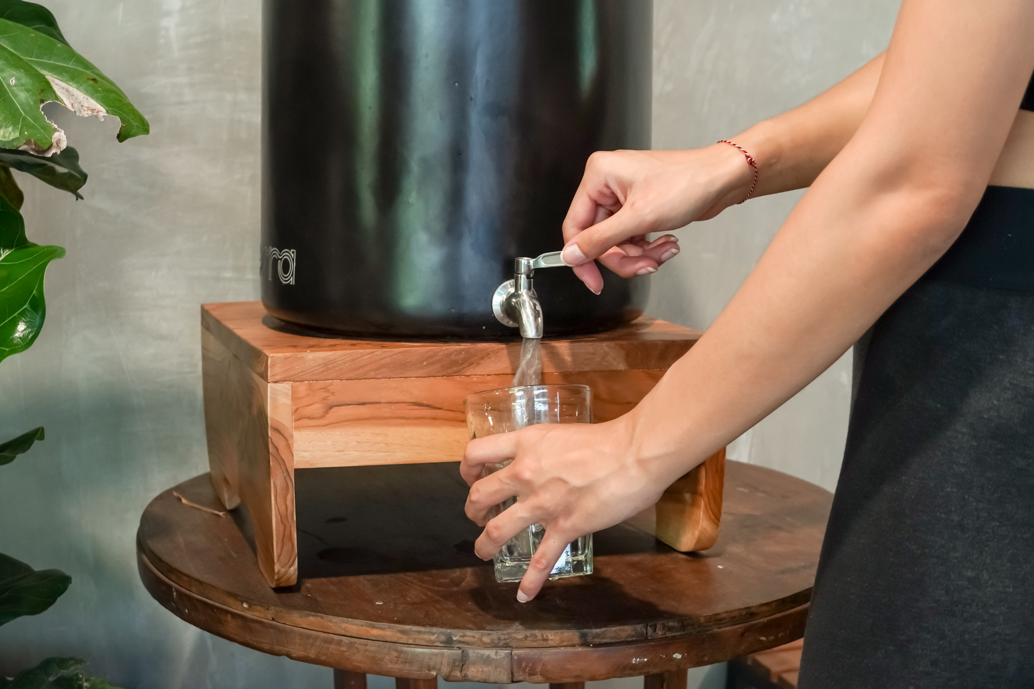 A Person Drinking From Terra Ceramic Water Filter Bali