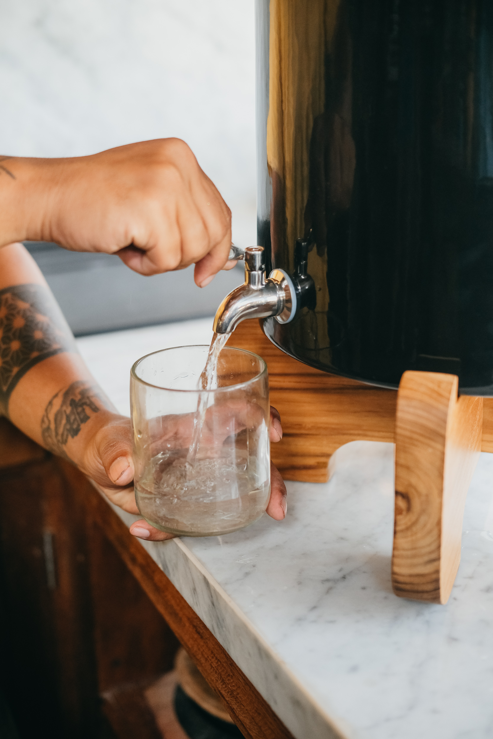 Individual getting water from a terra water filter
