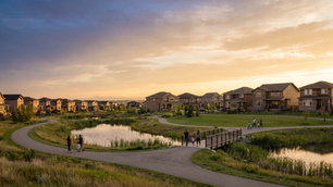 Representative Airdrie family communities with Alberta homes, park pathways and a pond at sunset