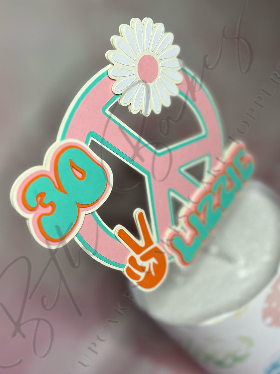 Diagonal view of pastel cake topper