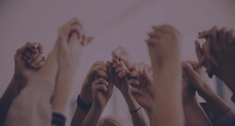 A diverse group of girls holding hands and celebrating