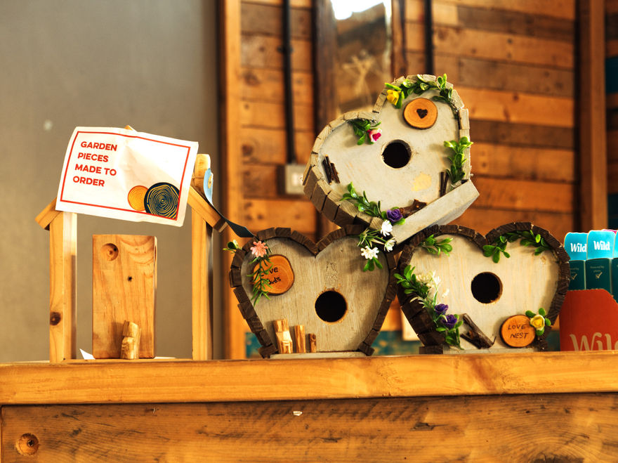 Pretty decorated hand made bird boxes for sale in shop.