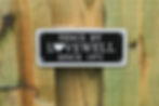 Lovewell Fence & Deck sign on wood fence