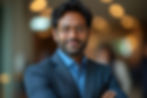 confident-indian-corporate-leader-smiling-with-arms-crossed-professional-business-setting.