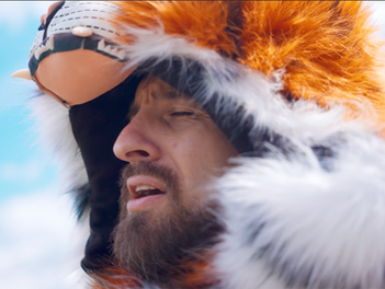 Man singing with a tiger hat on