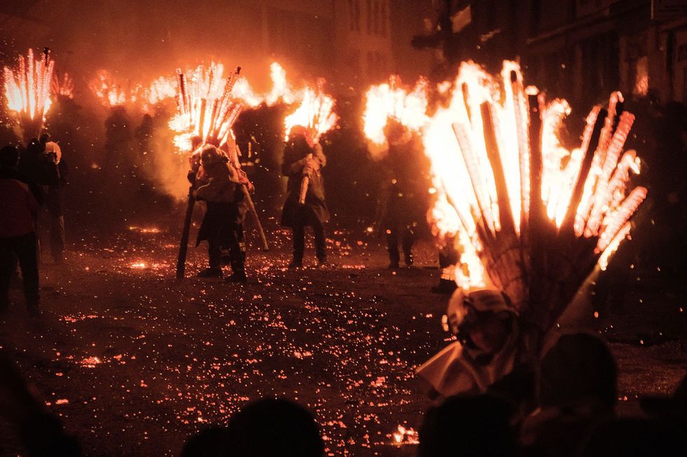 Parade of burning brooms in the streets of Liestal during Chienbäse, symbolizing driving away winter.