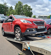 Car stuck in park being winched on with skates.