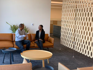 Two friends and collegues enjoying each other on a couch