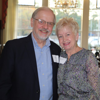 A man and a woman smile at the camera