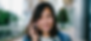 photo of a woman smiling while speaking on the phone