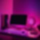 Image of Computer and cell phone on desk, futuristic with hot pink and purple ambient ligh