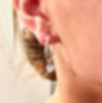 Handmade Sterling Silver Heart Hoop Earrings on model 
