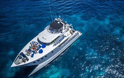 Stunning drone view of a private yacht party cruising in Bali's turquoise waters