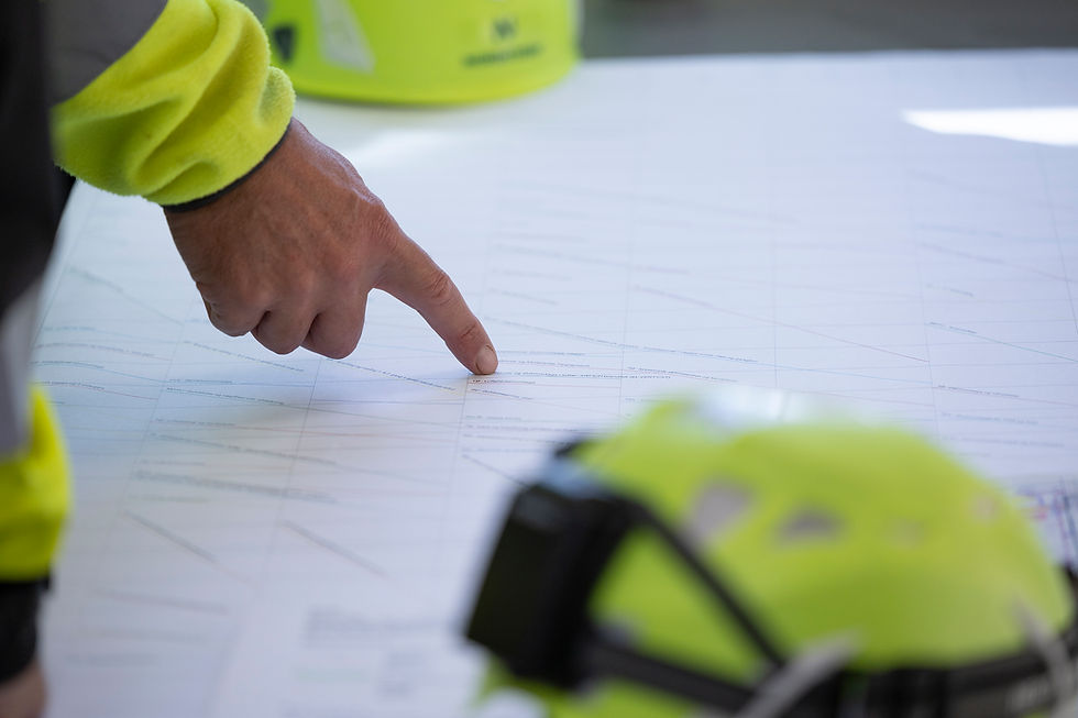 Engineer pointing at technical defense industry plans