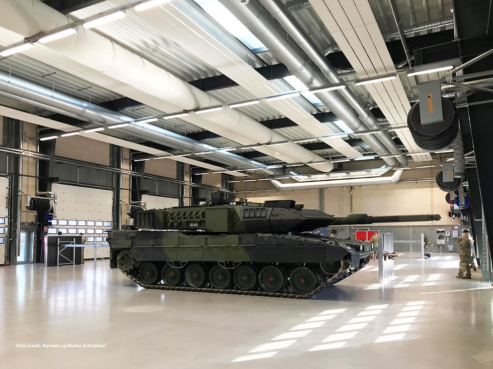 Military tank inside an industrial defense facility