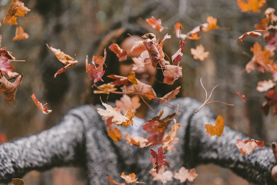 autumn image girl dancing in leaves