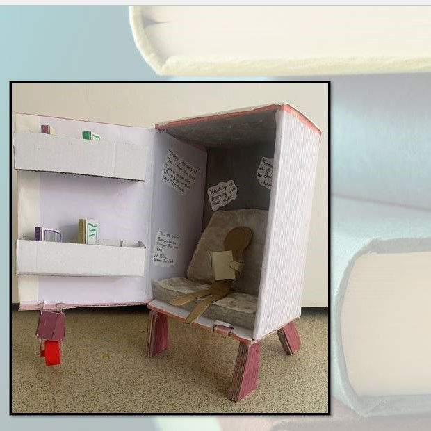 Diorama depicting a person inside a book-shaped refrigerator
