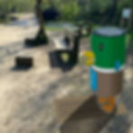 Duck-shaped recycling bin by park benches