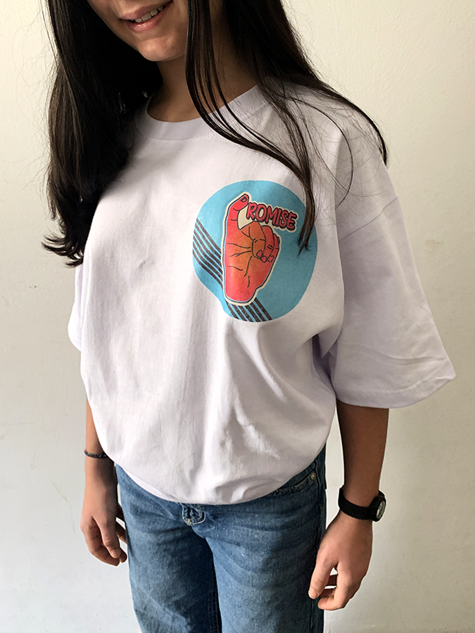 Person wearing white "POWER" graphic tee