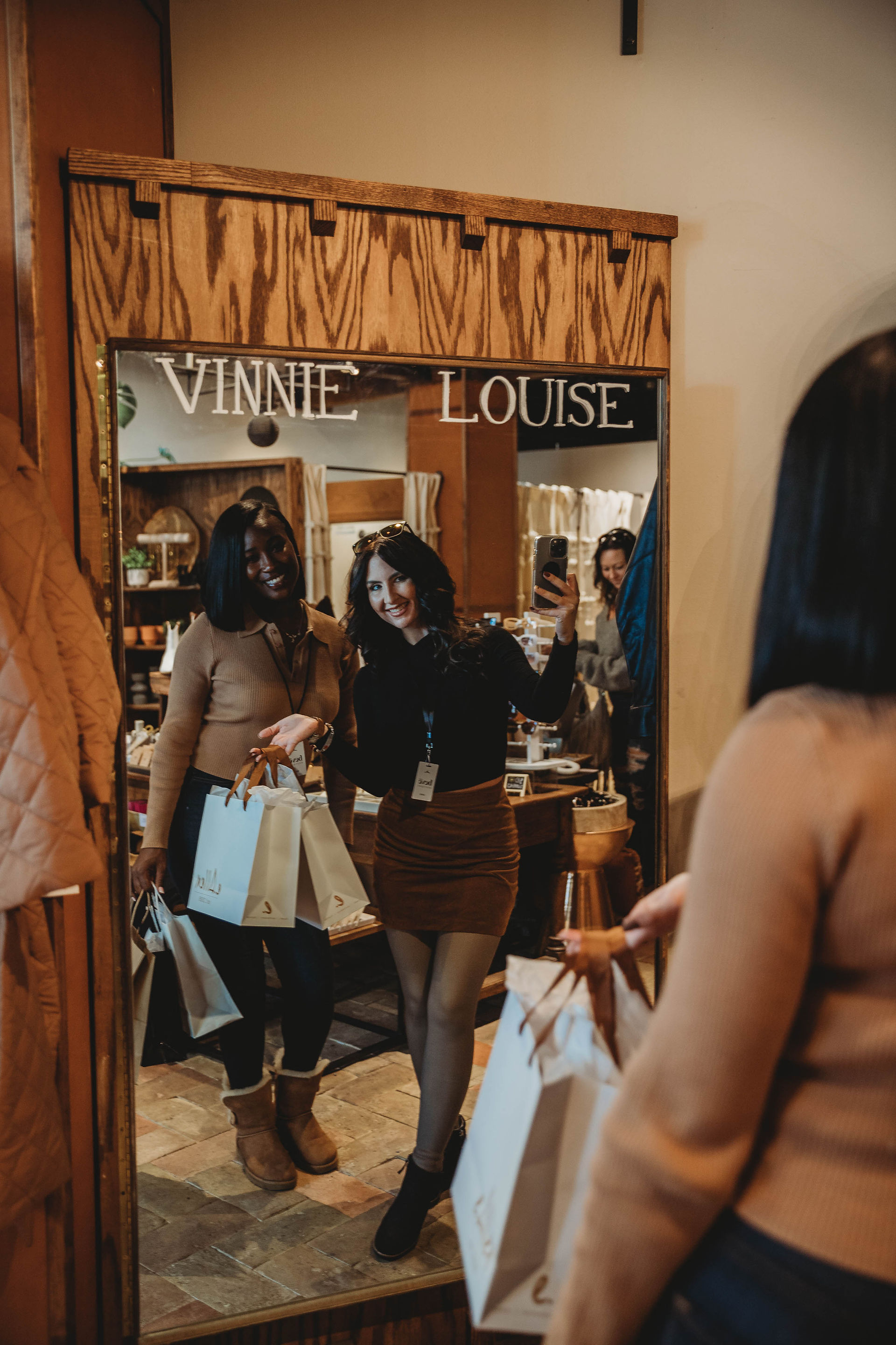 Women show off their shopping bags