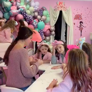 Young girls at a salon getting their nails painted