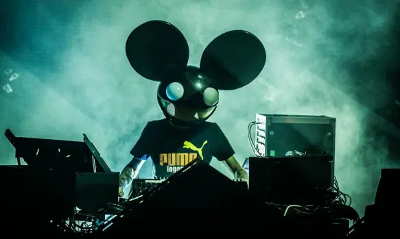 A picture of Deadmau5 during a concert at his DJ booth.
