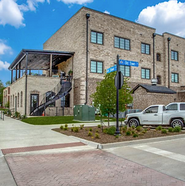 side view of building with retail on bottom and residential on top