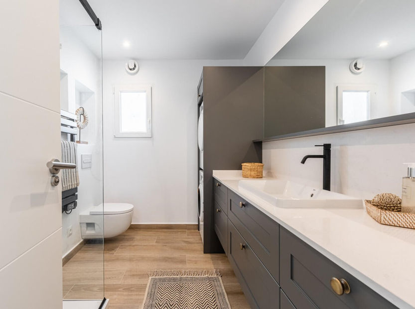 Modern bathroom with black fixtures and walk-in shower
