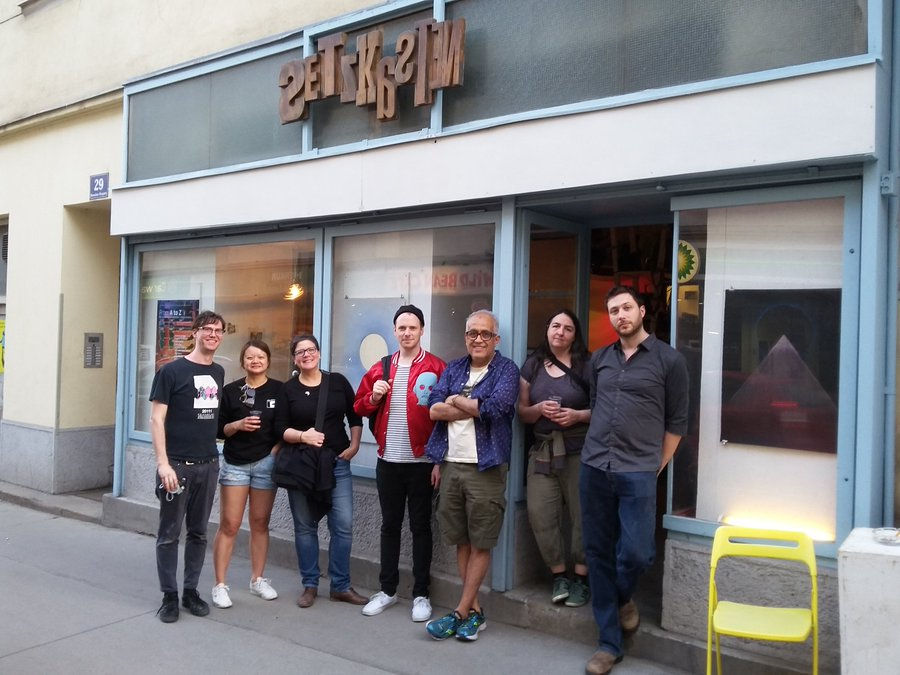 Artists posing in front of gallery