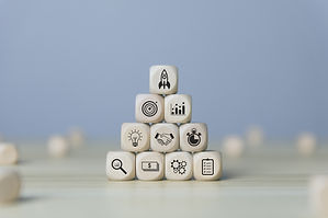 10 white wooden blocks stacked up in a pyramid shape