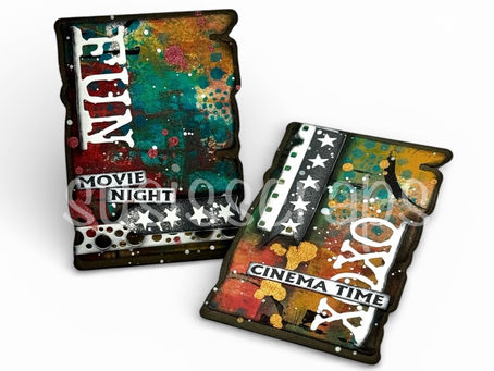 Mixed media ATC cards with colourful layered backgrounds, film strip elements, stars, and black and white movie-themed details