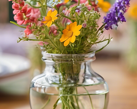 small vase of wild flowers, close up on a table setting with the background blurred and fo