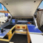 The Pin Drop galley kitchen open showing all features, counter top space and two burner propane stove.