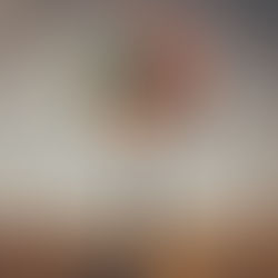 a man holding colourful balloons in a farm