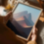 Minimal landscape art print of layered mountains with warm golden light and soft blue sky.