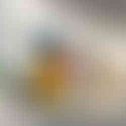 Side profile of red lips with abstract background in blue, mustard, and white tones