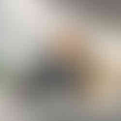 Geometric mountain scene with lake reflection and large orange sun in the sky