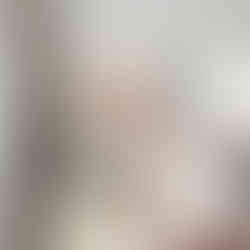 Abstract pastel landscape with stylized waves and a soft yellow sun.