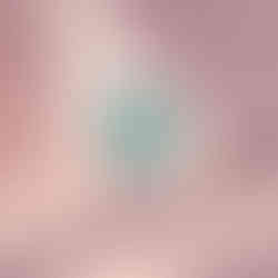 Bright turquoise bathroom with a large window showing a sunny sky and green trees.