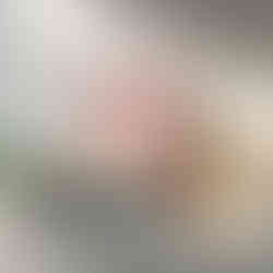 Pastel coastal lighthouse with waves and soft clouds in a serene seascape.