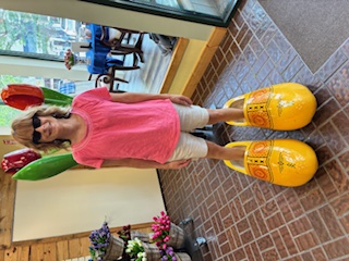 Stacey goofing around in a pair of shoes that are about as big as she is!