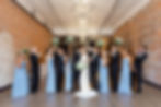 Wedding party raising a toast against the exposed brick wall at The 3 Ten.