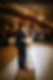 Couple sharing their first dance under string cafe lights and chandeliers at The 3 Ten.